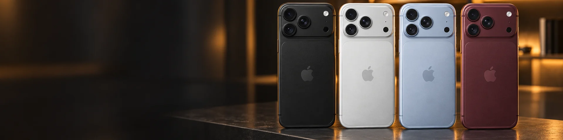 Cuatro iPhone 18 Pro Max, negro, plata, azul y vino, lado a lado sobre una mesada de metal cepillado